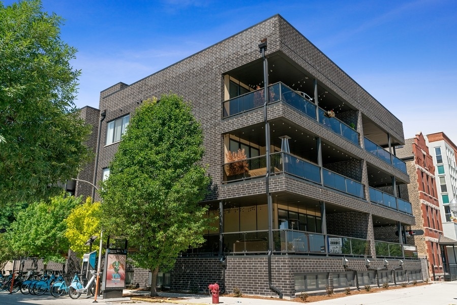 a front view of a building with a tree