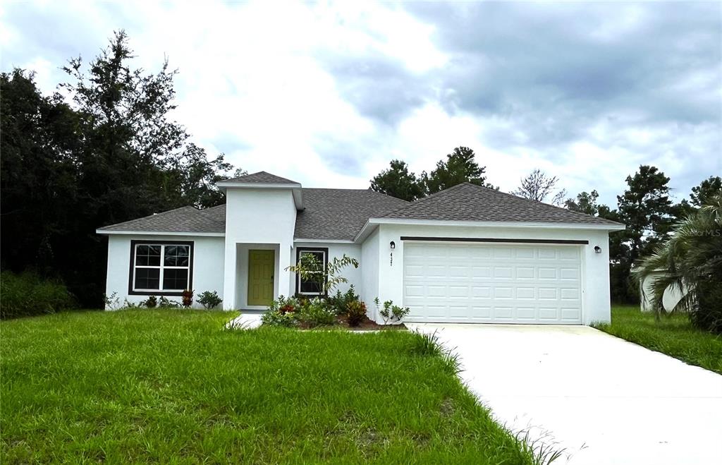 a front view of house with yard and green space