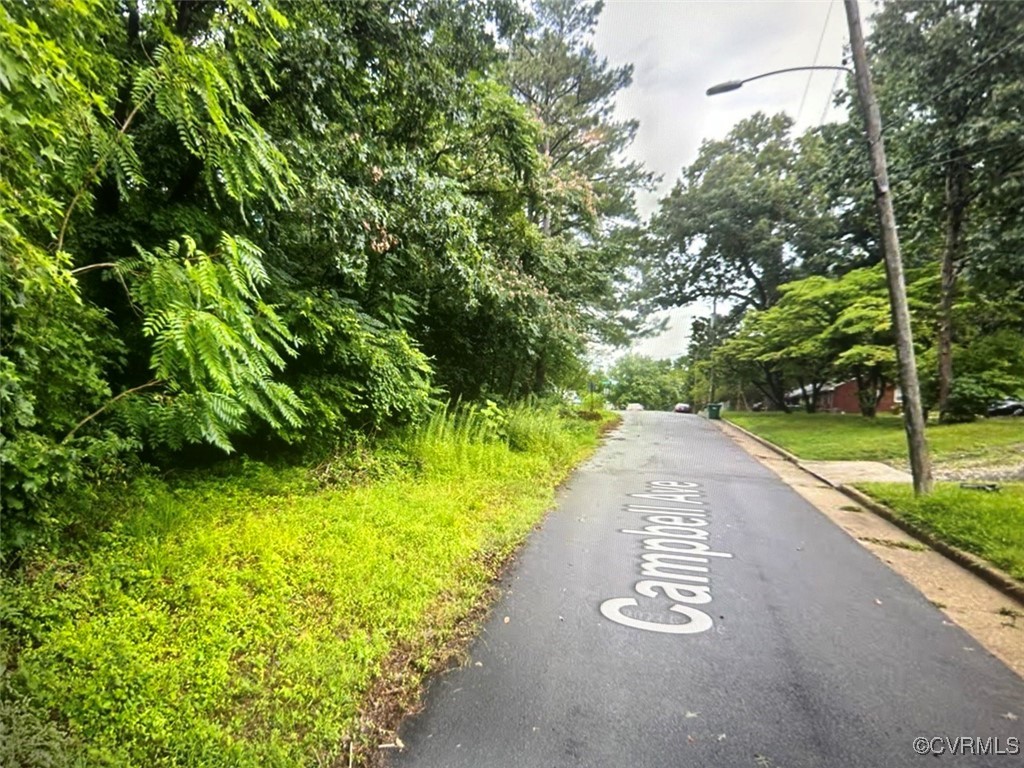 a view of a street with a yard