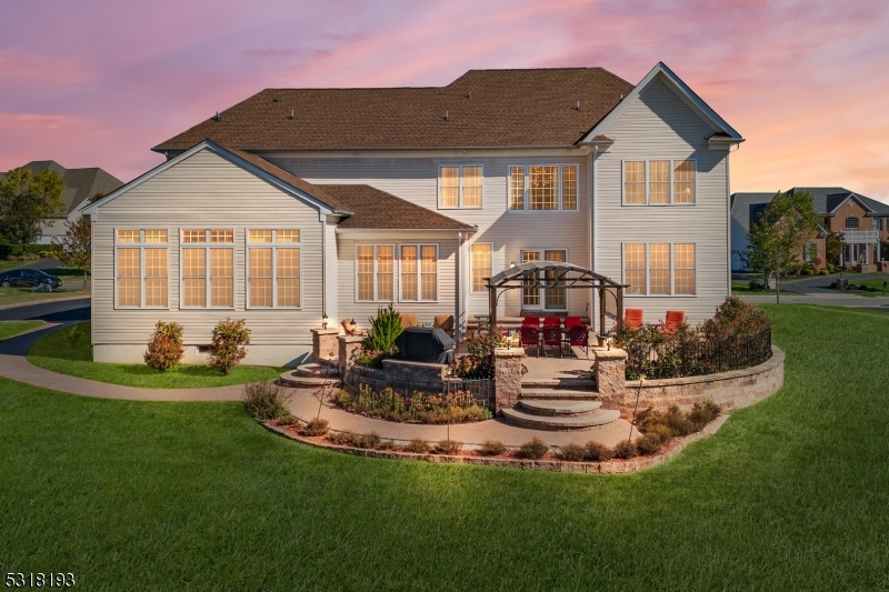 a front view of a house with a garden and patio