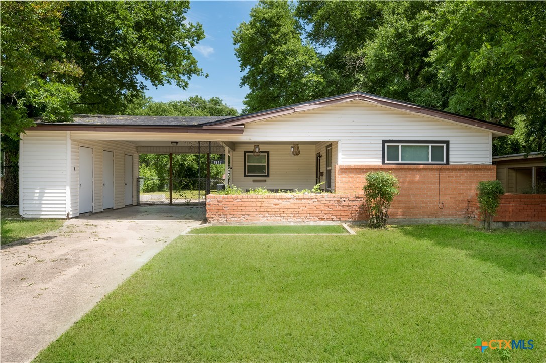 a front view of house with yard and green space