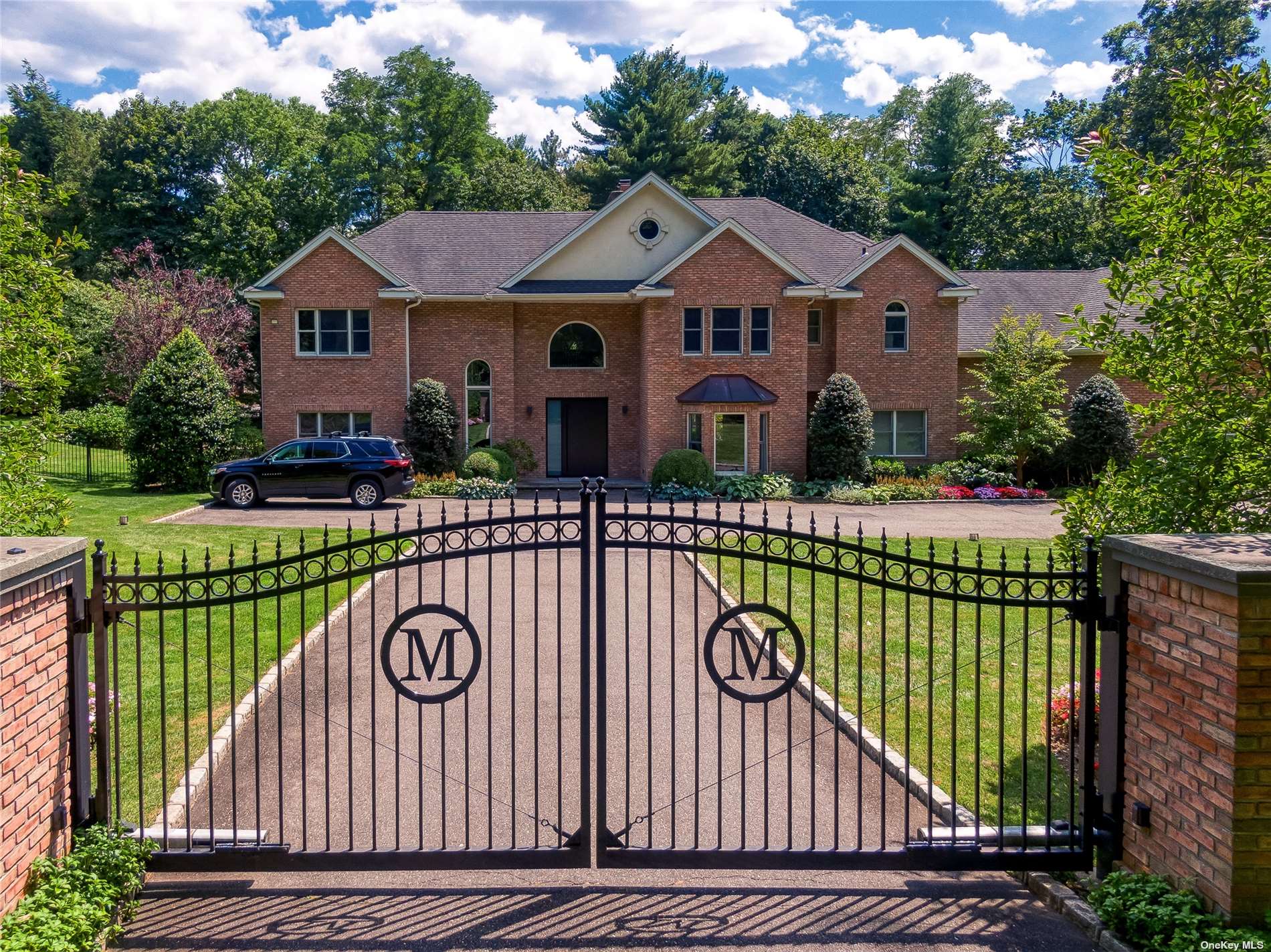 a front view of a house with a garden and deck