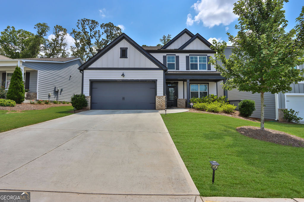 a front view of a house with a yard and garage