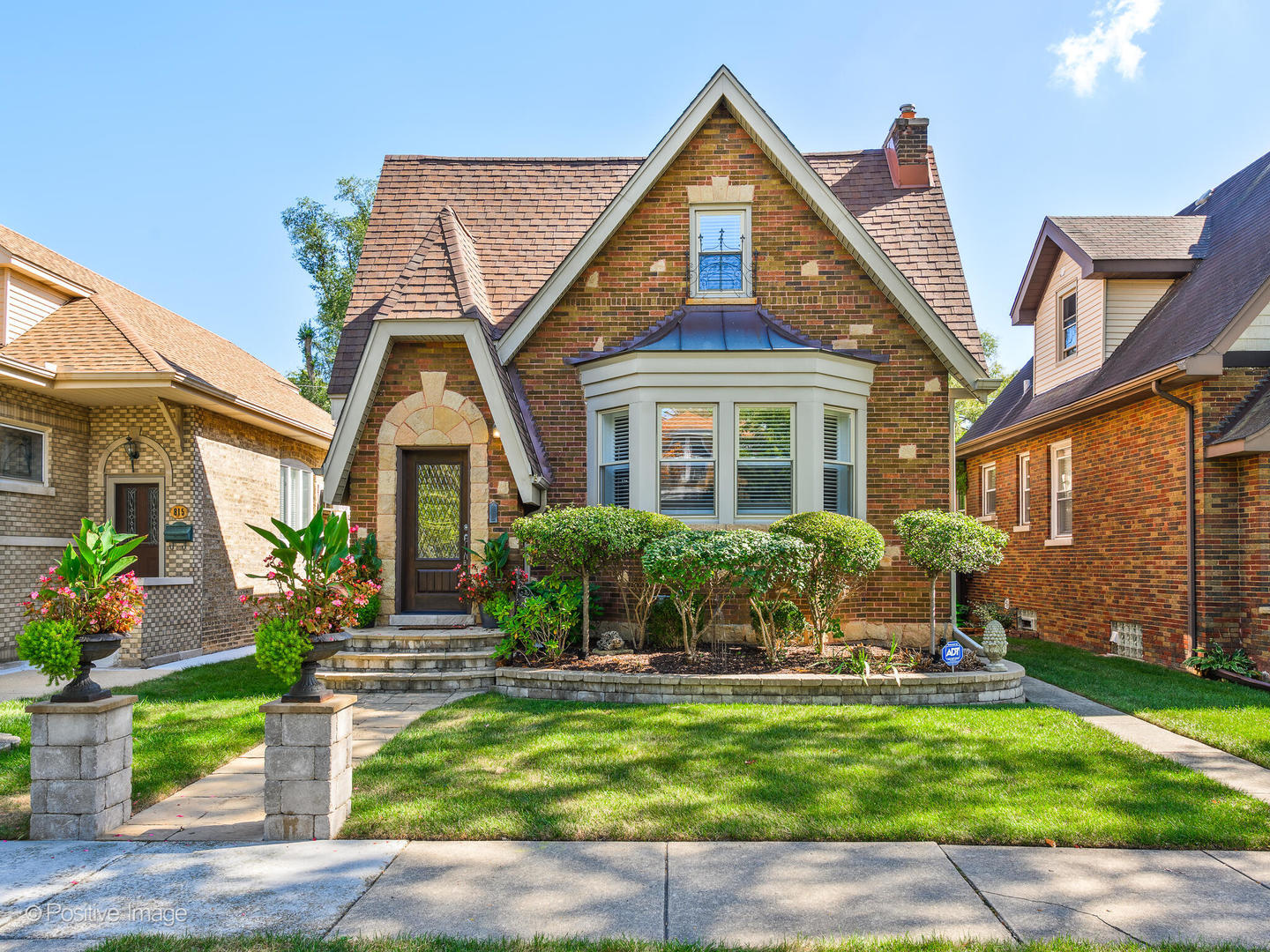 a front view of a house with a garden