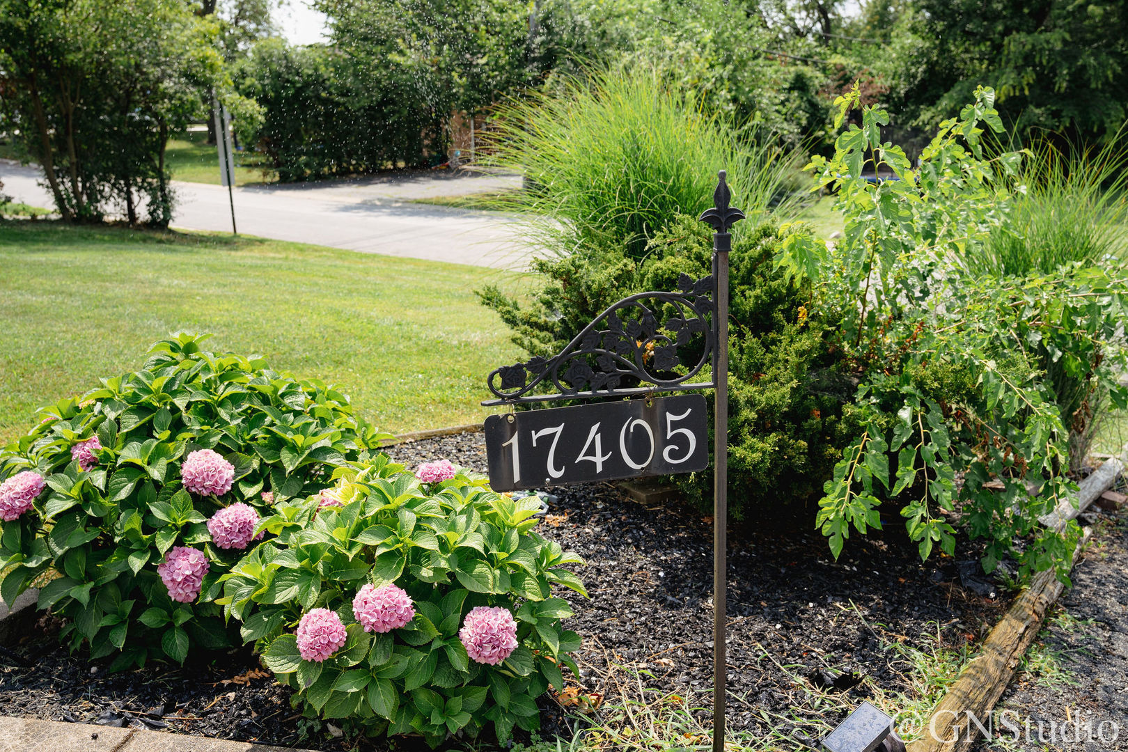 a sign that is in front of flowers