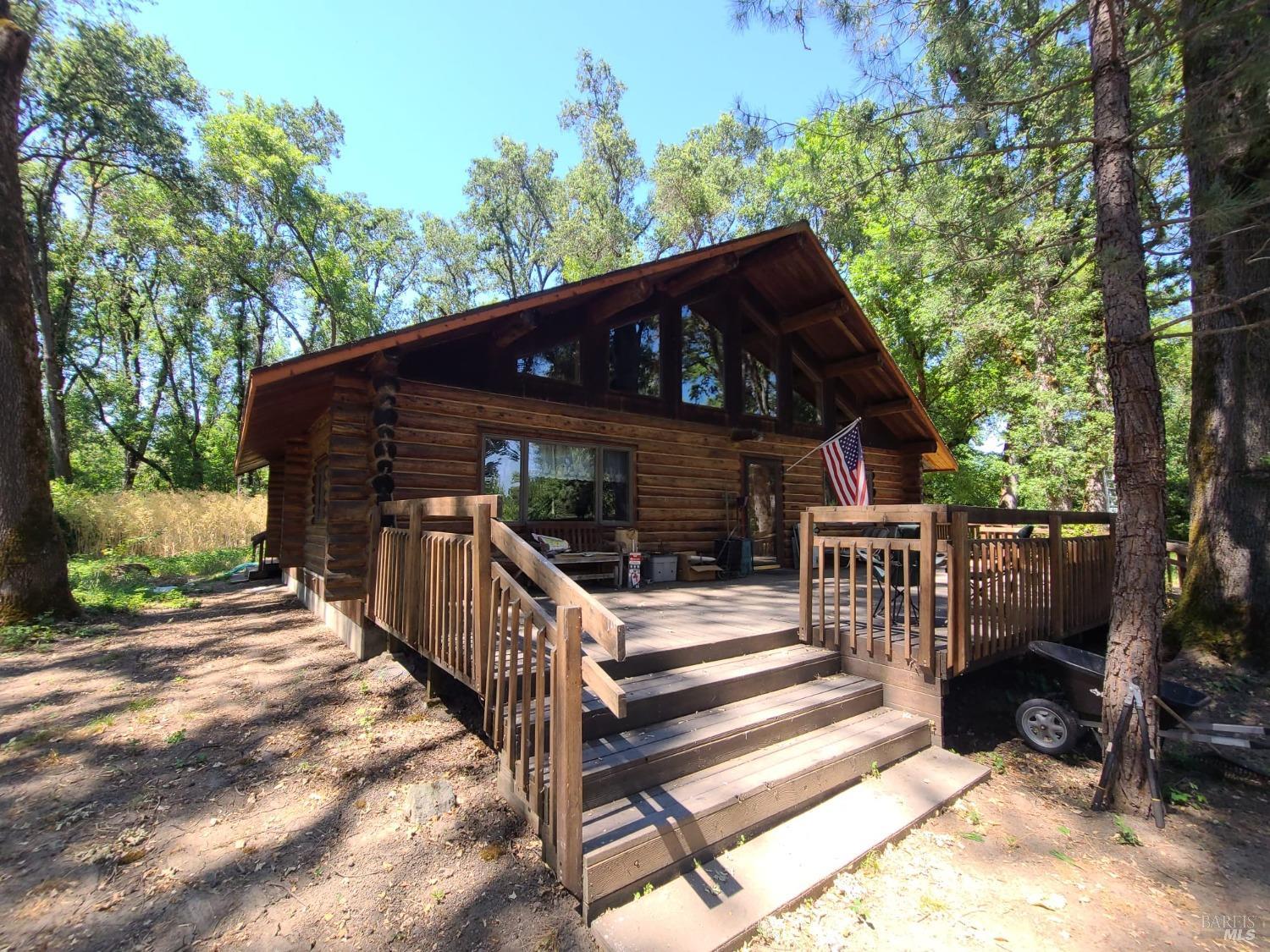 a view of house with backyard and trees