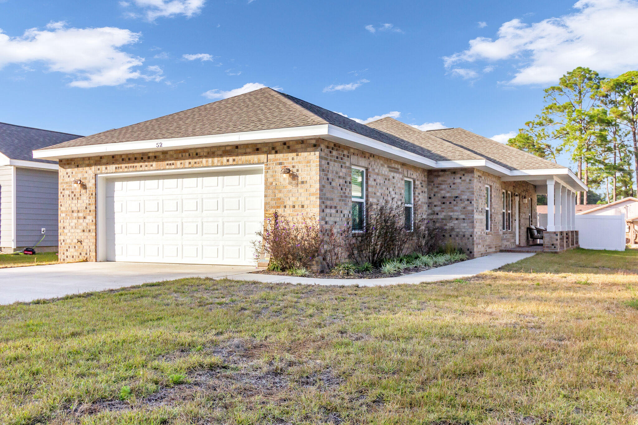 a view of a house with a yard and a garage