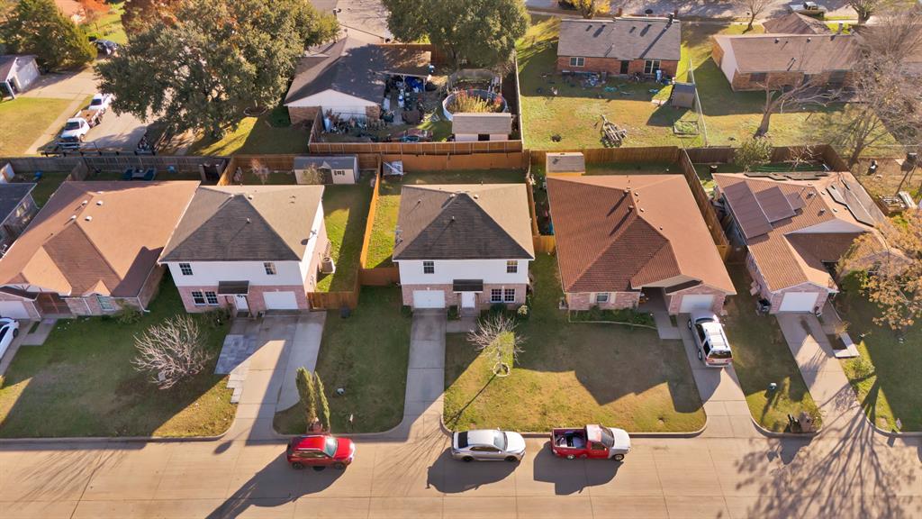 an aerial view of residential houses with outdoor space and swimming pool