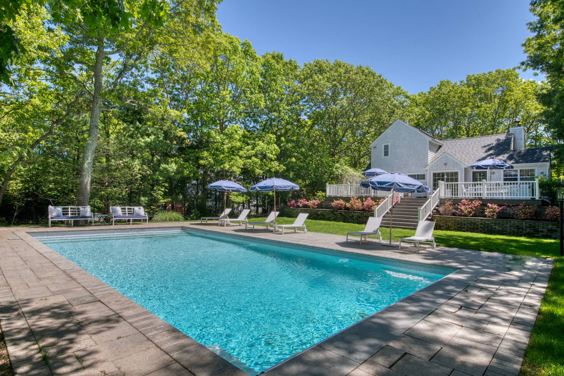 a view of a house with backyard porch and sitting area