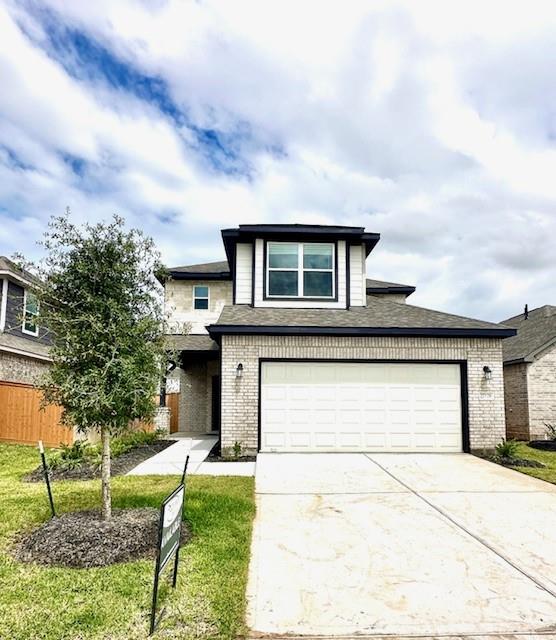 a front view of a house with a yard garage and outdoor seating