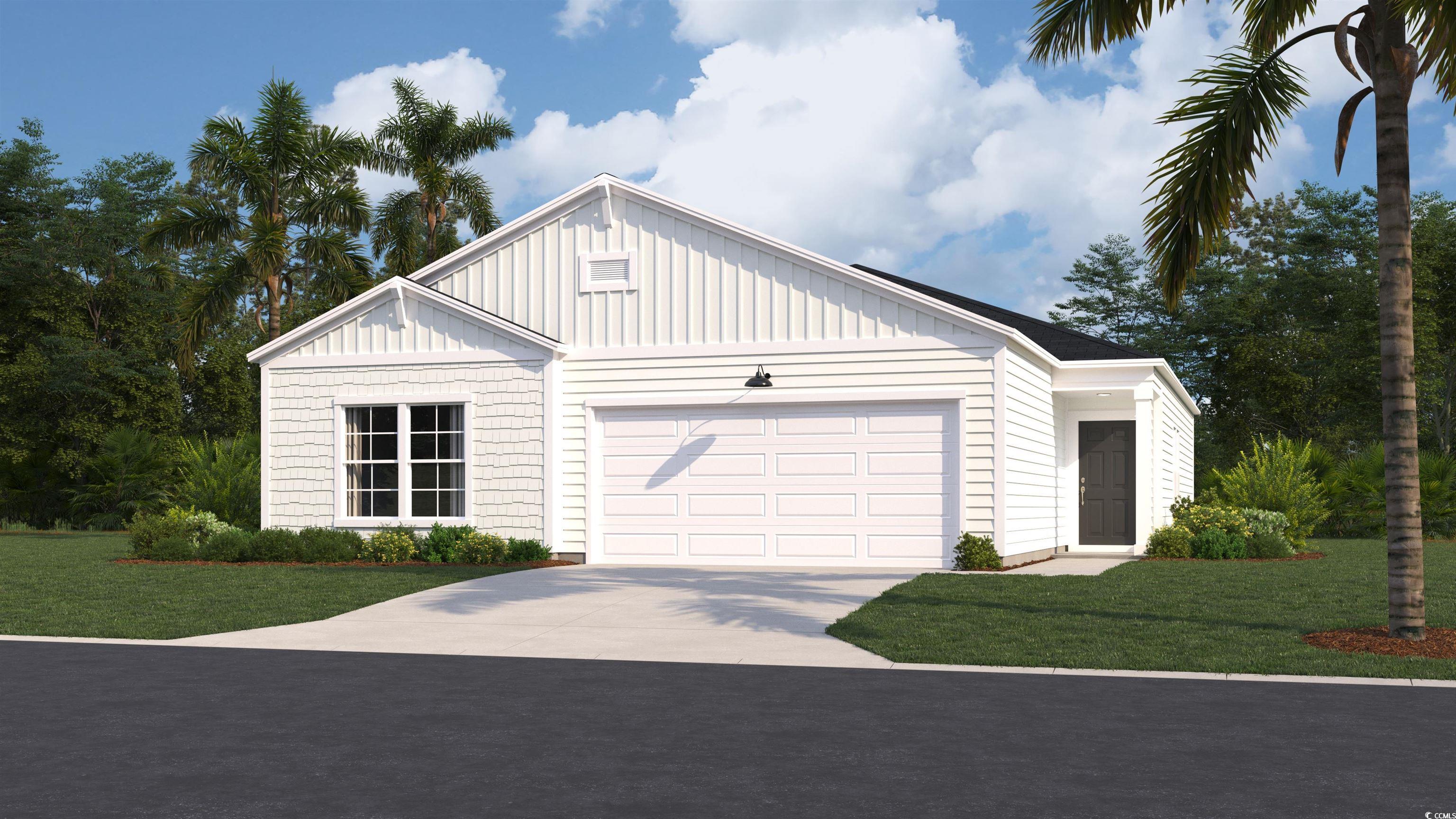 Modern farmhouse featuring a garage and a front ya