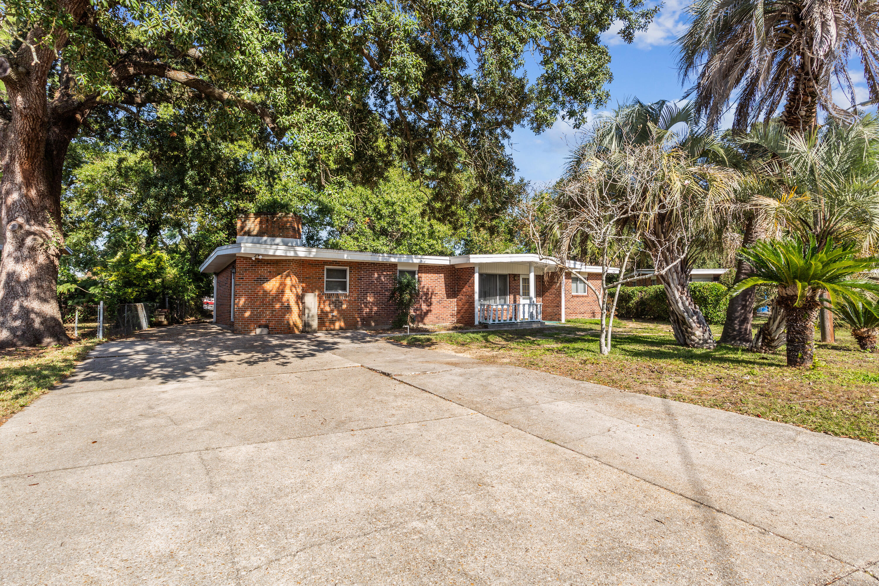 a view of a house with a yard and tree