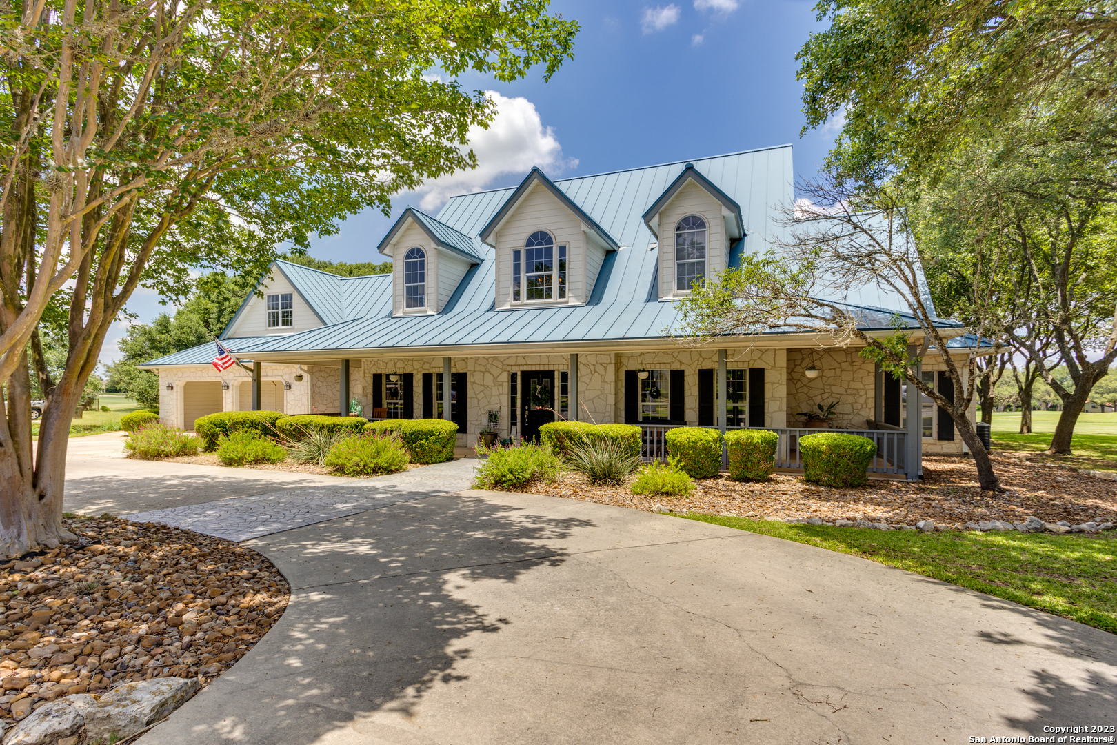 a front view of a house with a yard and porch