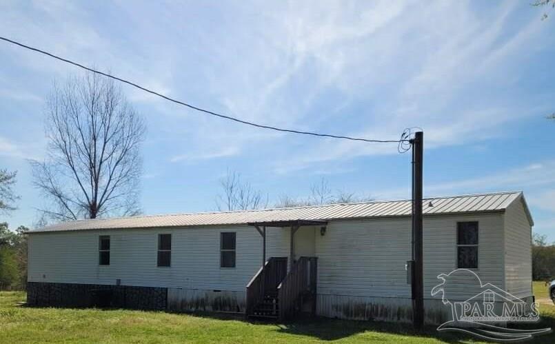 a backyard of a house with barbeque oven