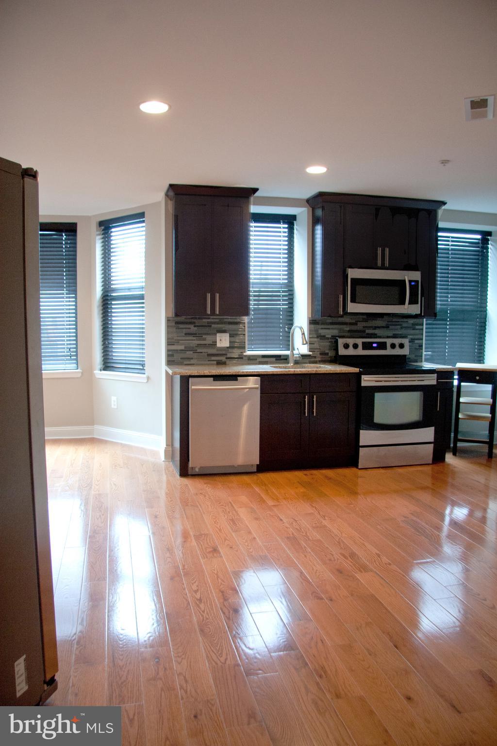 a view of kitchen with sink and microwave