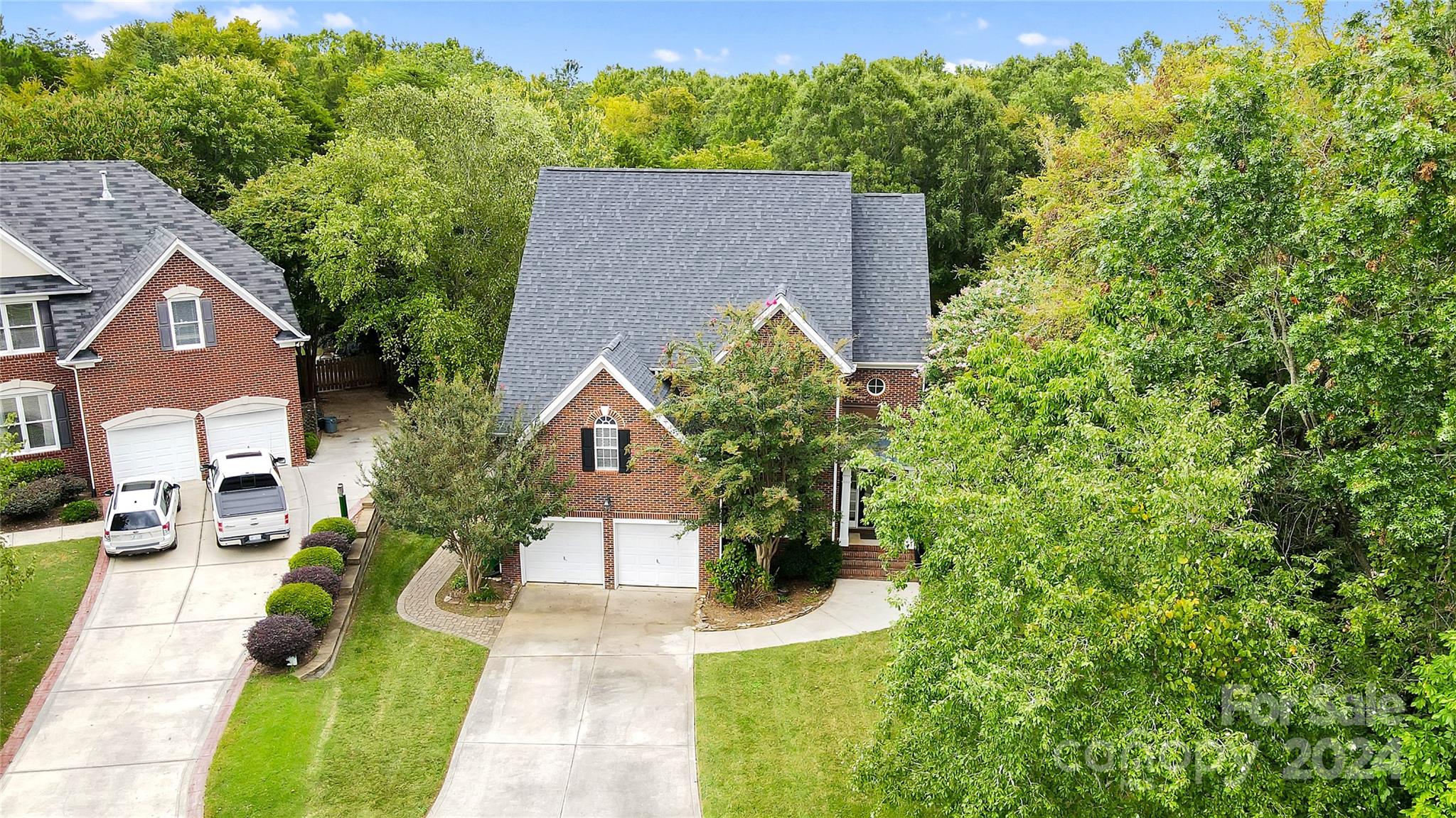 a aerial view of a house with a yard and potted plants