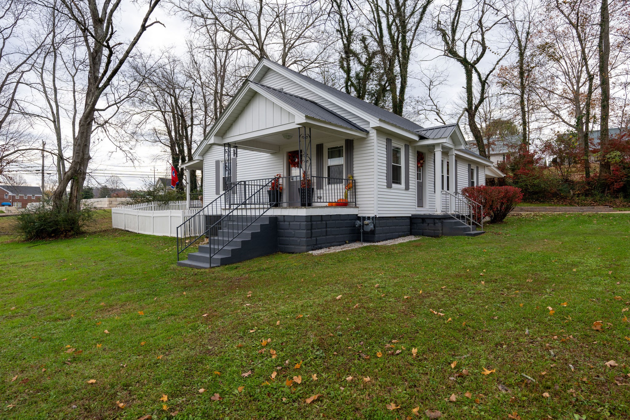 a front view of house with yard and green space