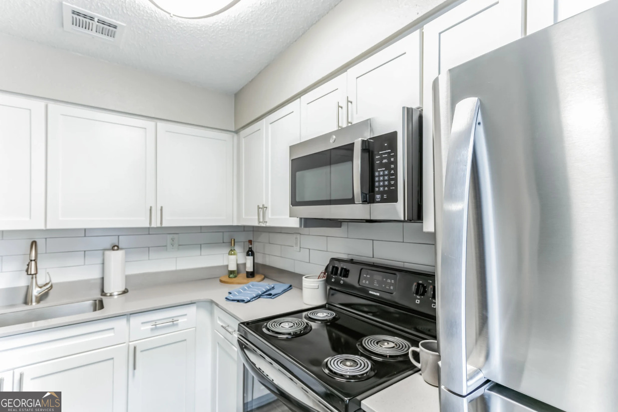 a kitchen with a stove and a sink