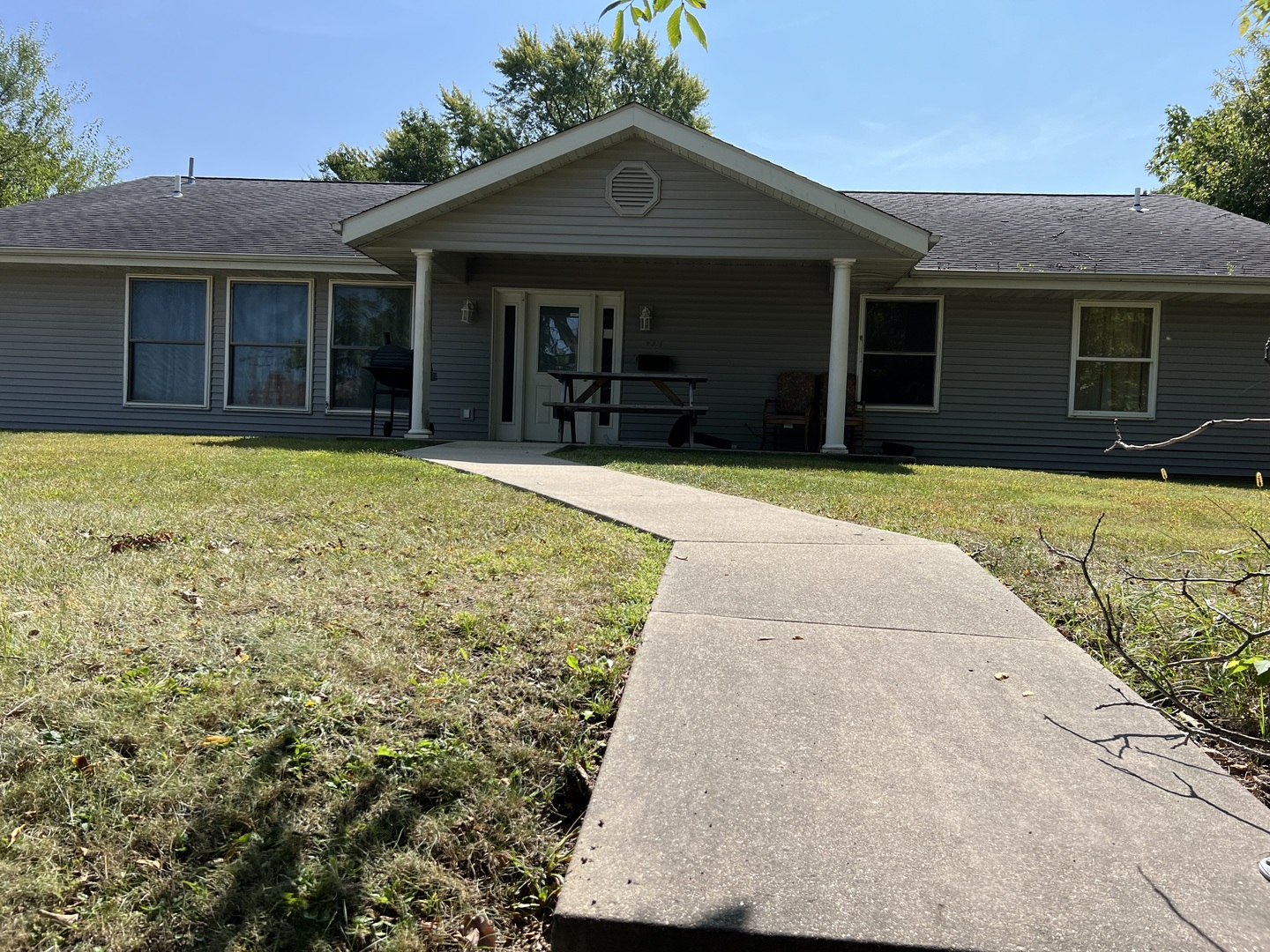 a front view of a house with a garden and yard