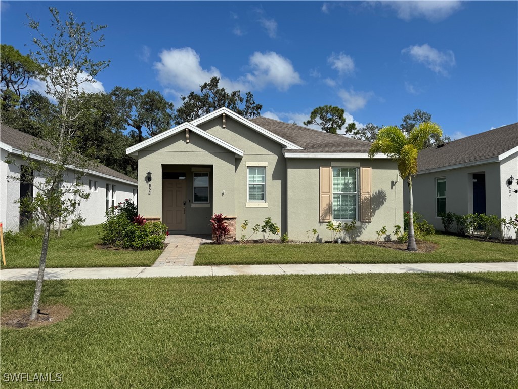 a front view of a house with a yard