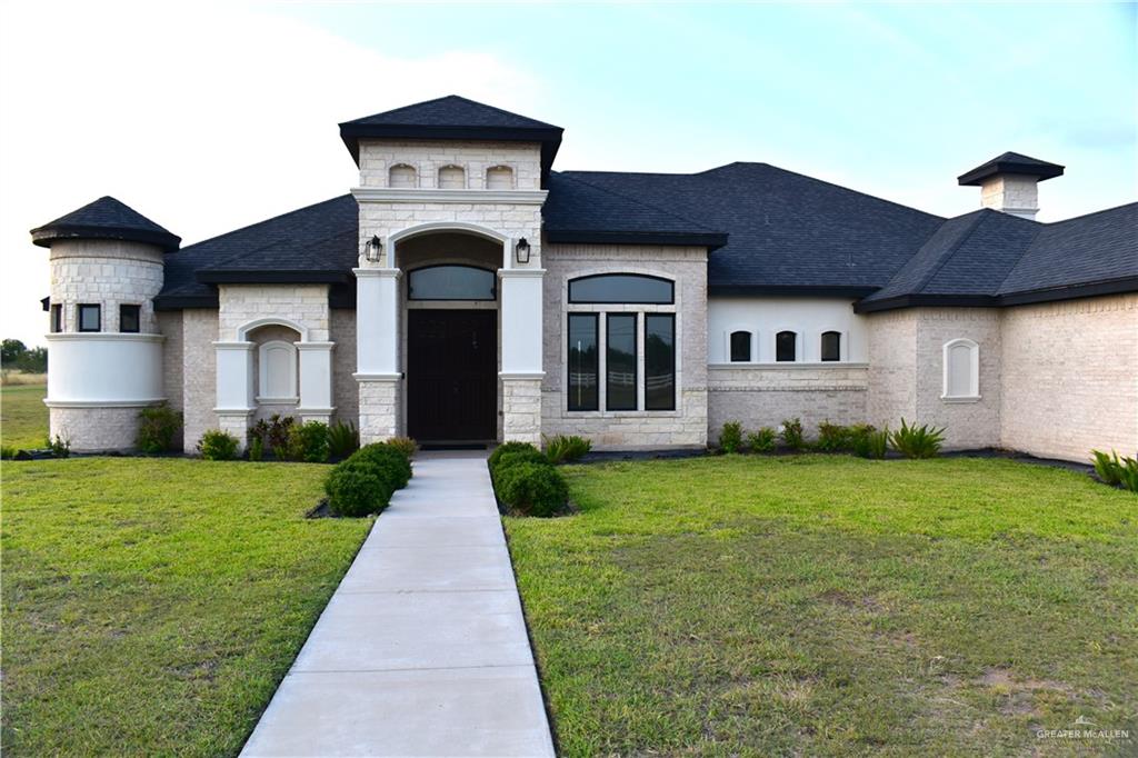 a front view of a house with garden