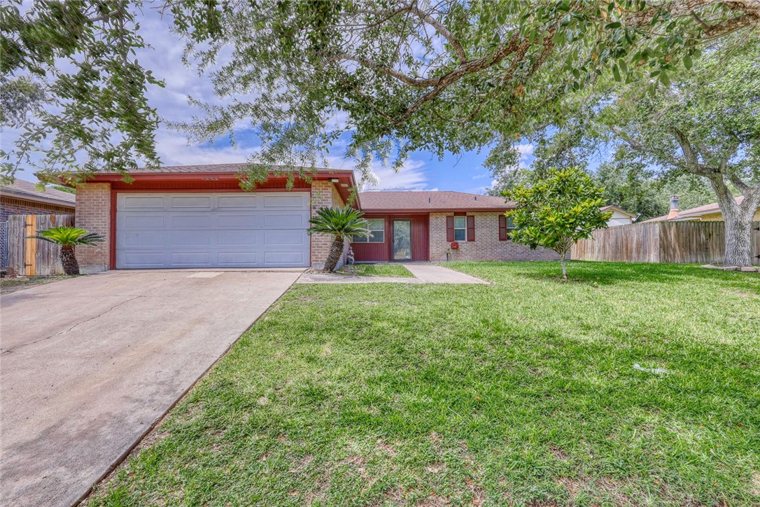 a front view of a house with a yard and a garage