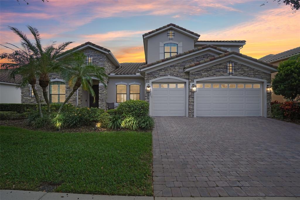 a front view of a house with a yard and garage