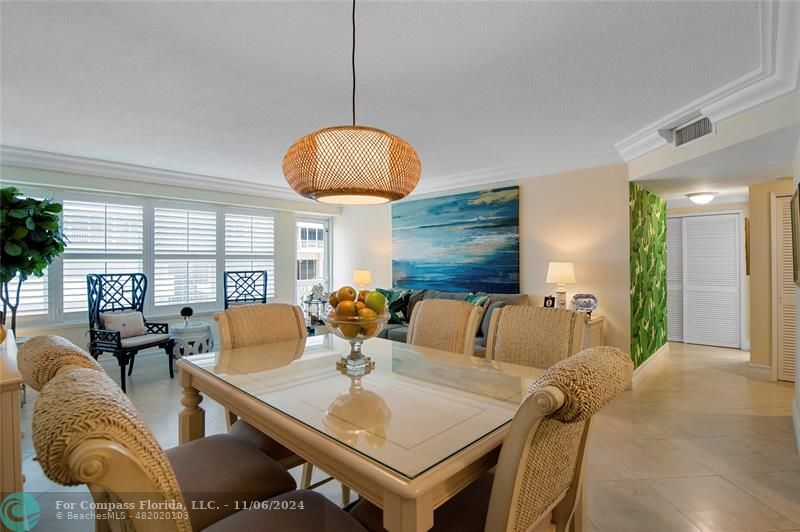 a living room with furniture a chandelier and a large window