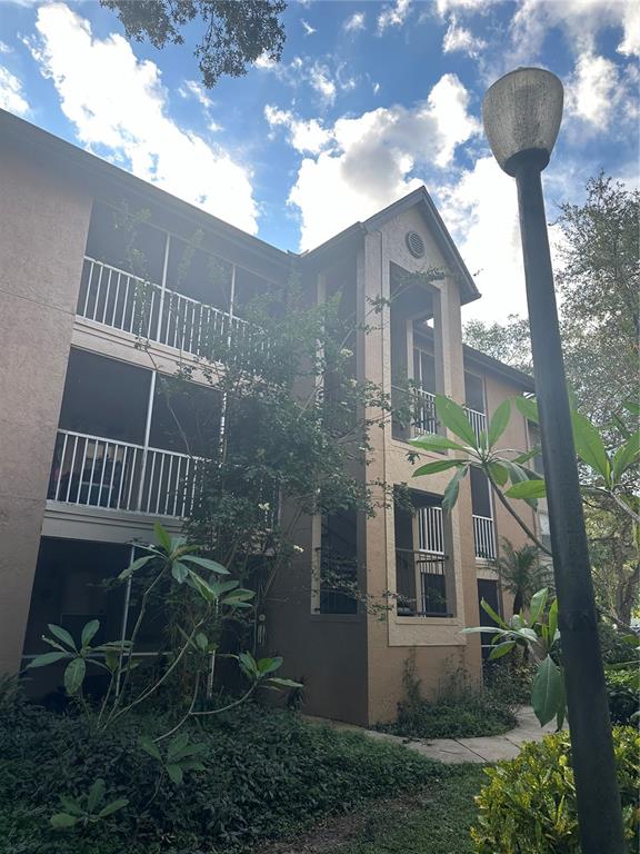 a view of a house with a yard and balcony