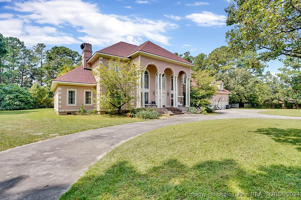 a front view of house with yard and green space