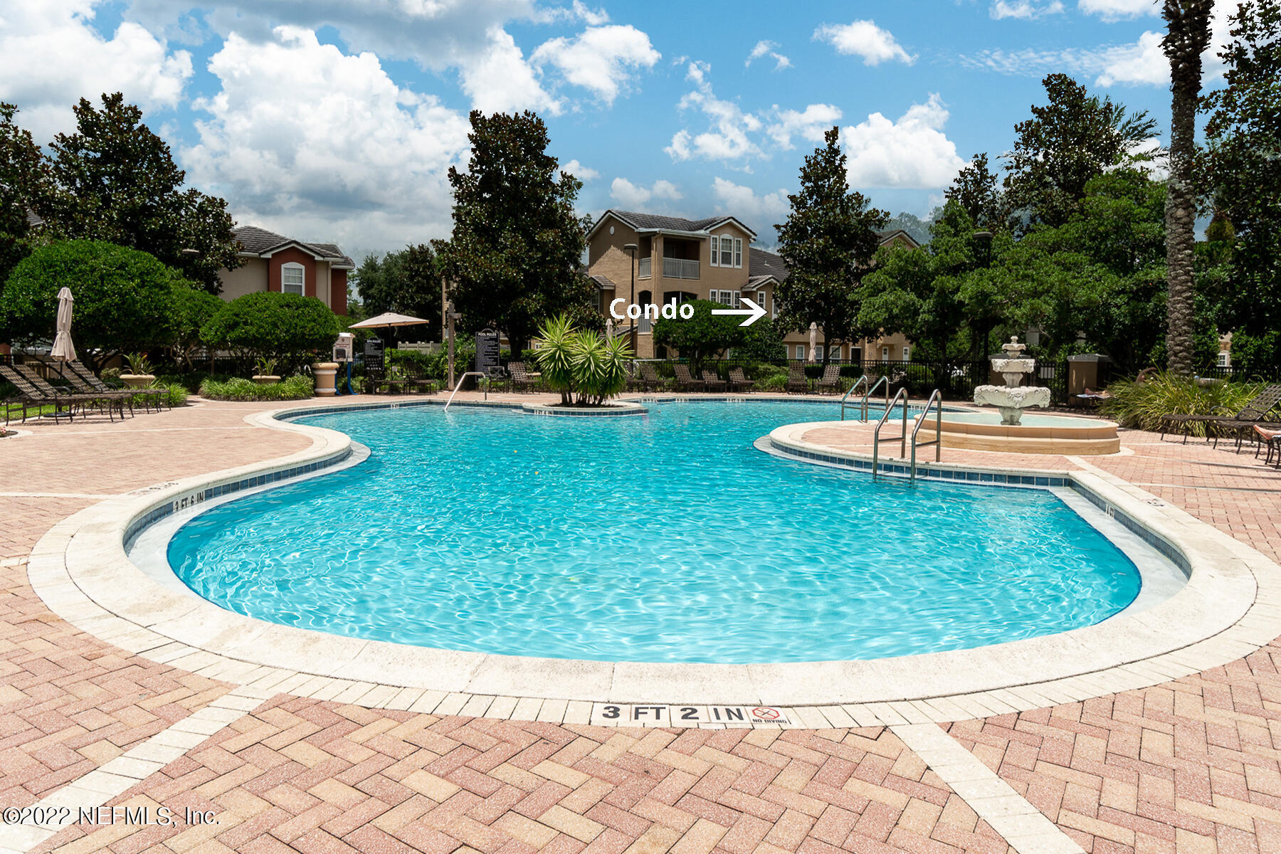 a view of a swimming pool with a yard