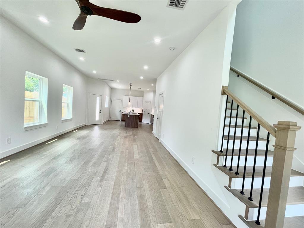 a view of empty room with wooden floor