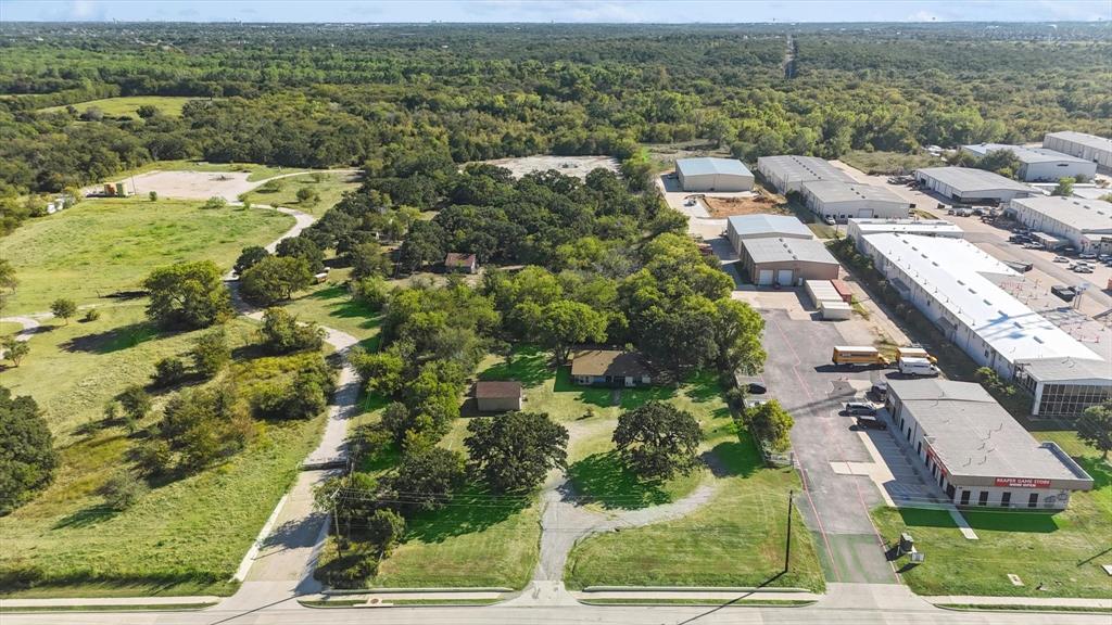 an aerial view of residential houses with outdoor space and street view