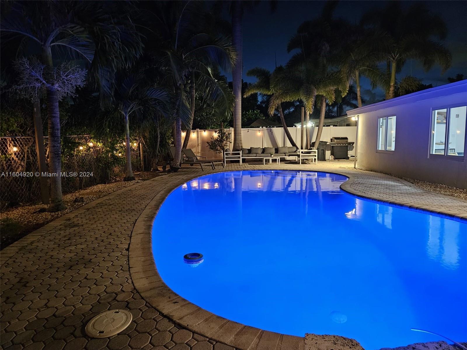 a view of a swimming pool with seating area