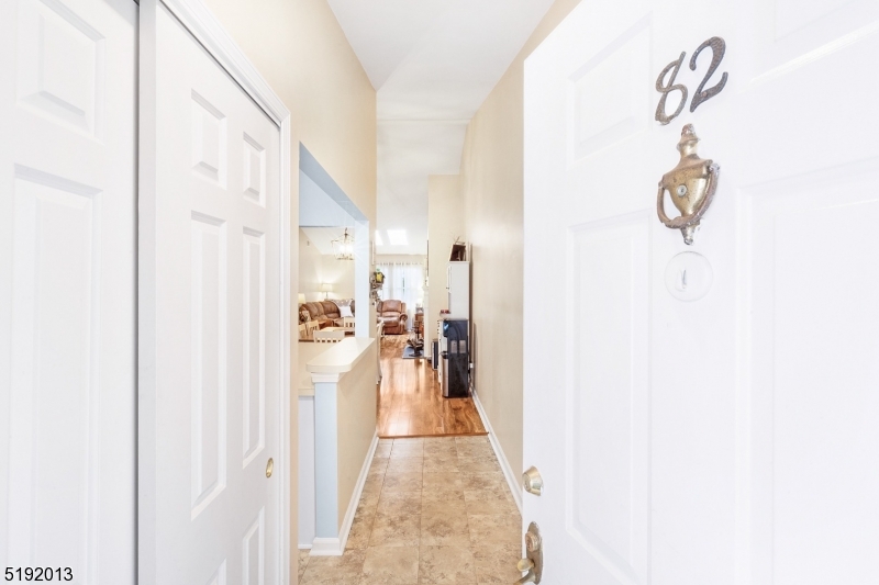 a view of a hallway with wooden floor and entryway