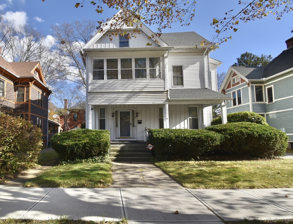 a front view of a house with a garden