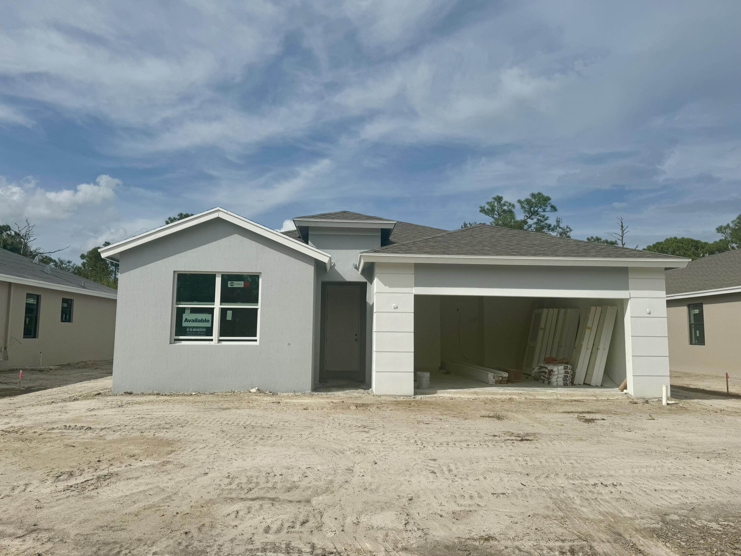 front view of a house with a yard and garage