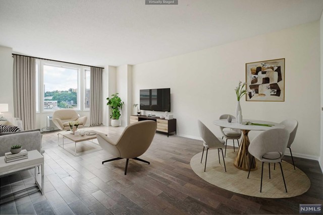 a living room with furniture a large window and a flat screen tv