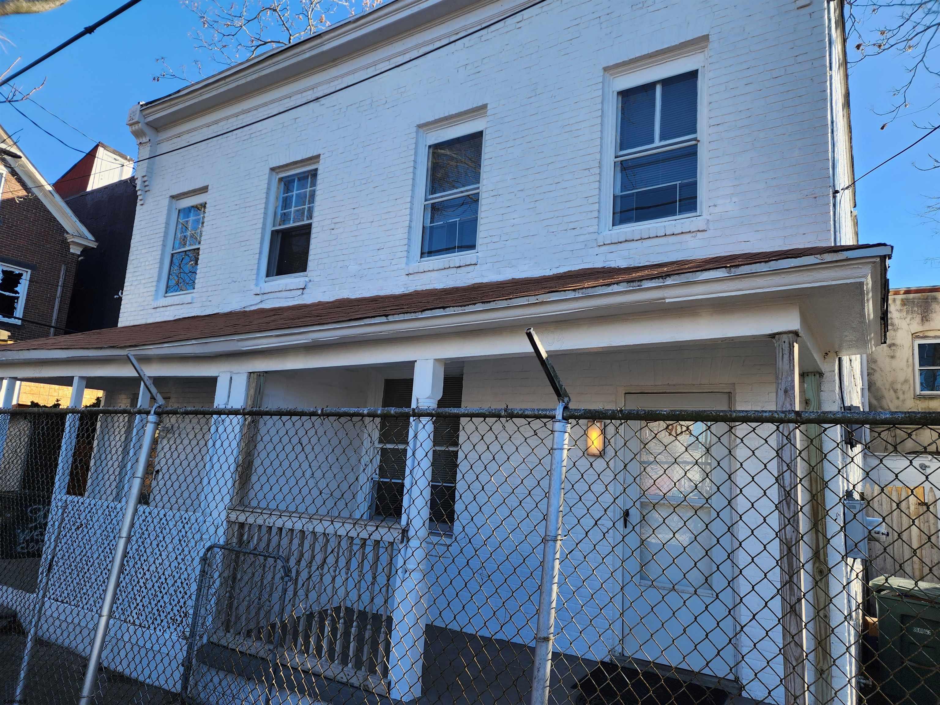 a view of a house with street deck and furniture