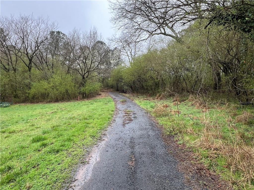 a view of a pathway with a yard