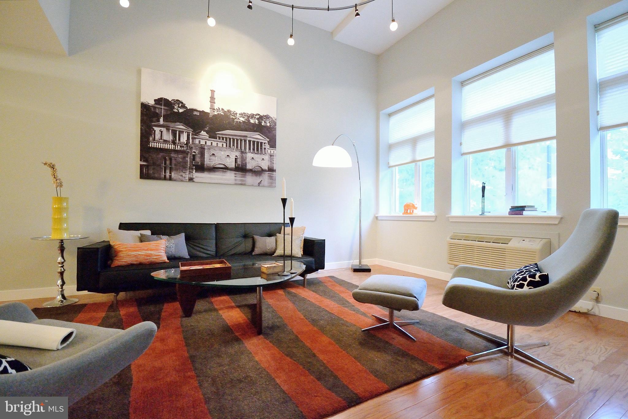 a living room with furniture and a large window