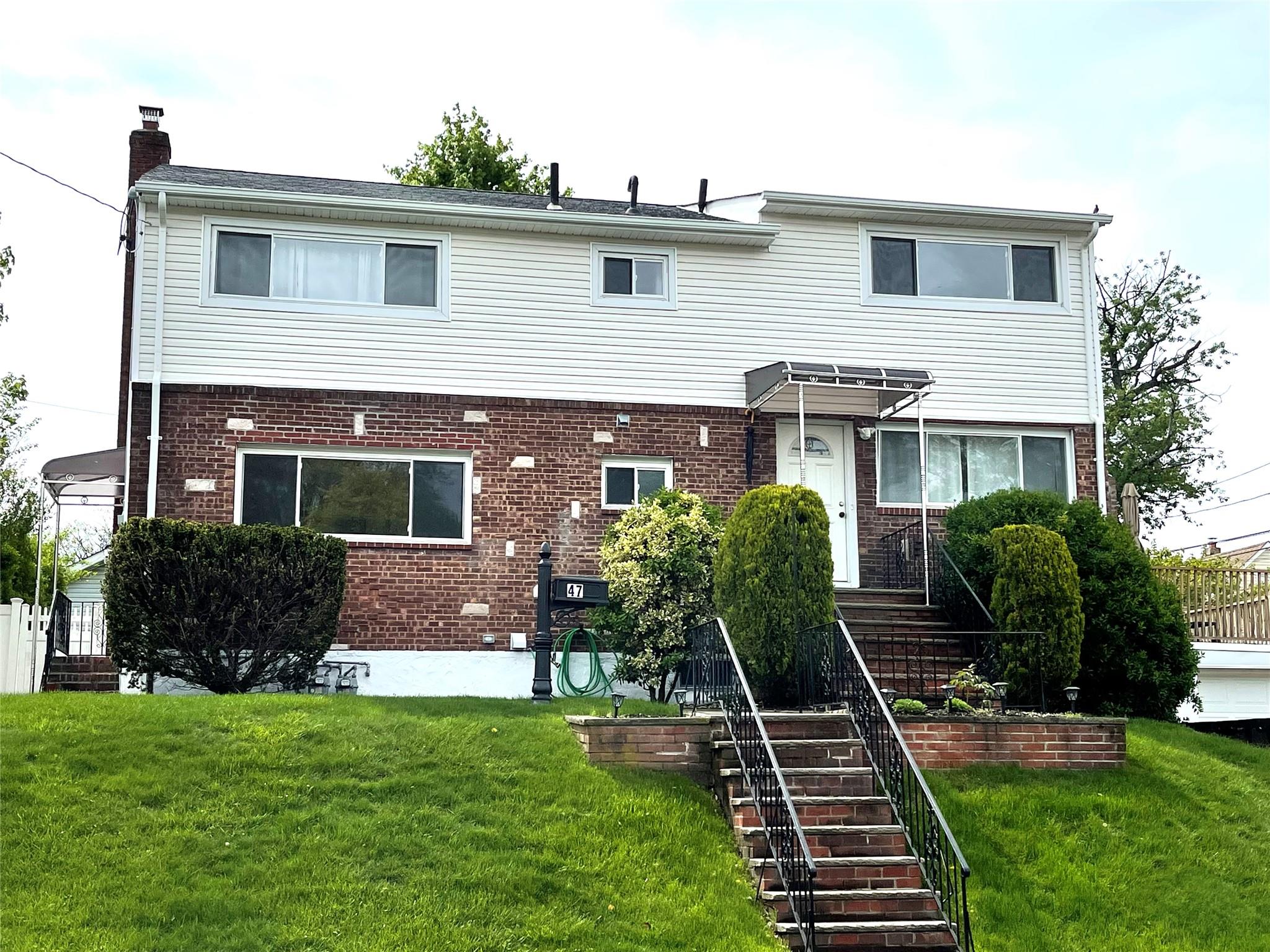 a front view of house with yard and green space