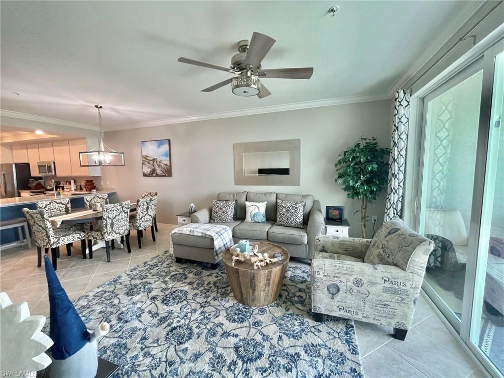 a living room with furniture and a chandelier