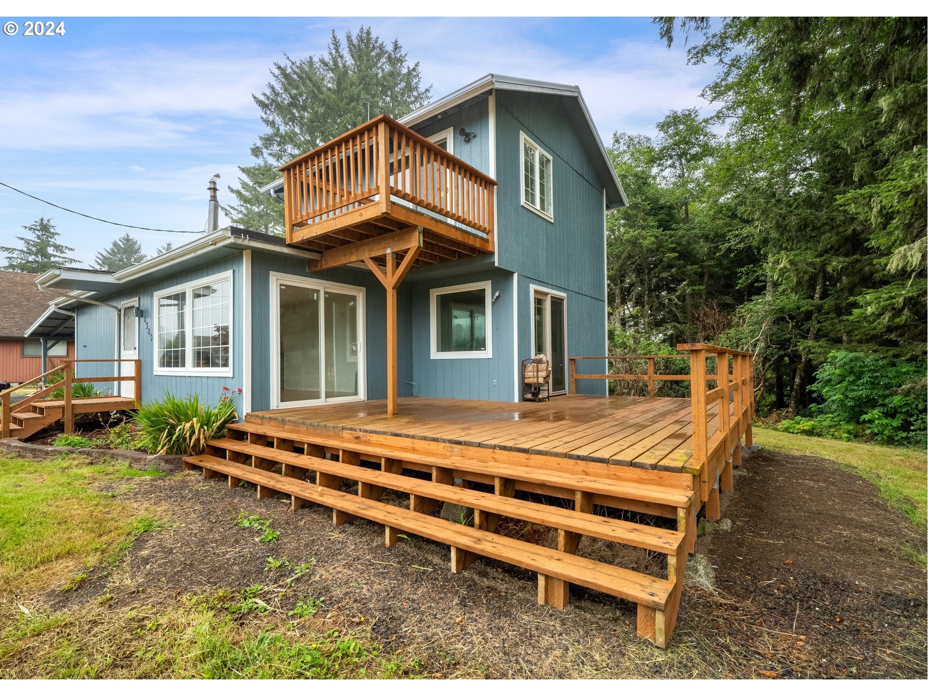 a backyard of a house with a garden and deck