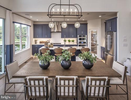 a kitchen with a table and chairs in it