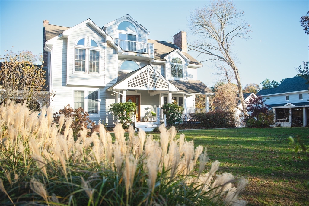 a view of a house with yard and sitting area