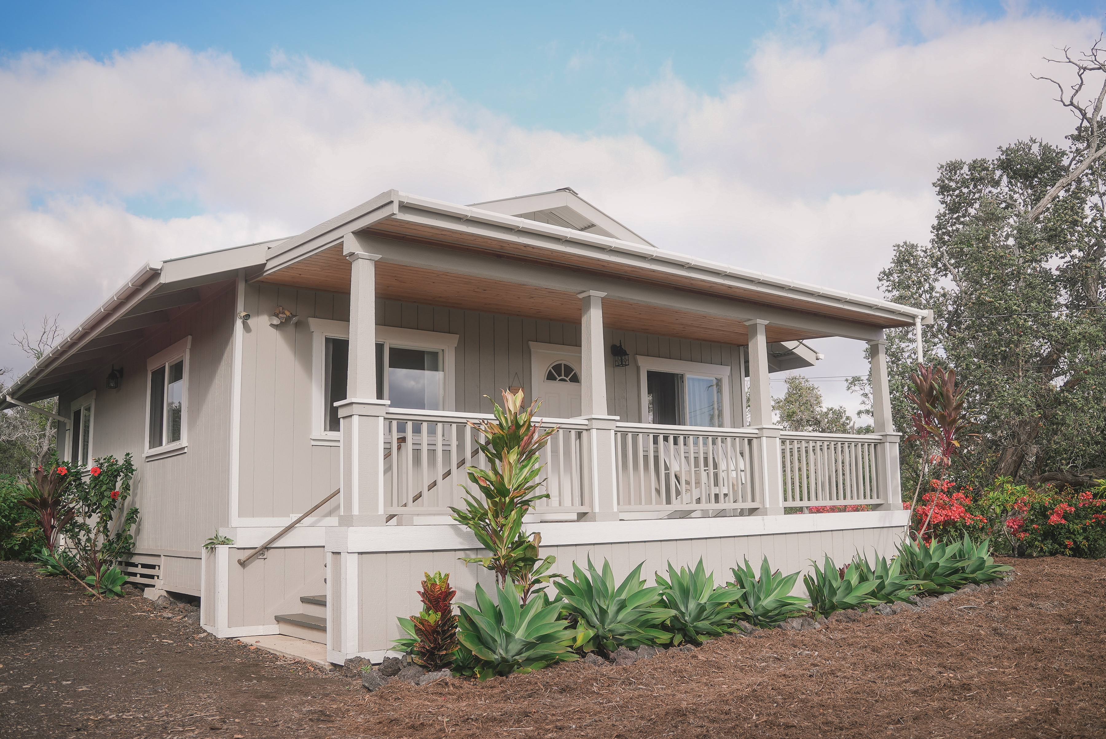 a front view of a house with a garden