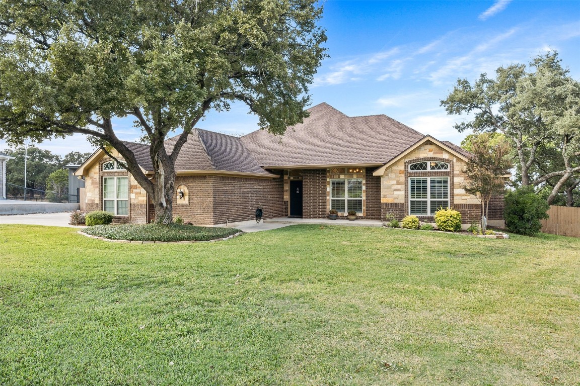 a front view of a house with a garden