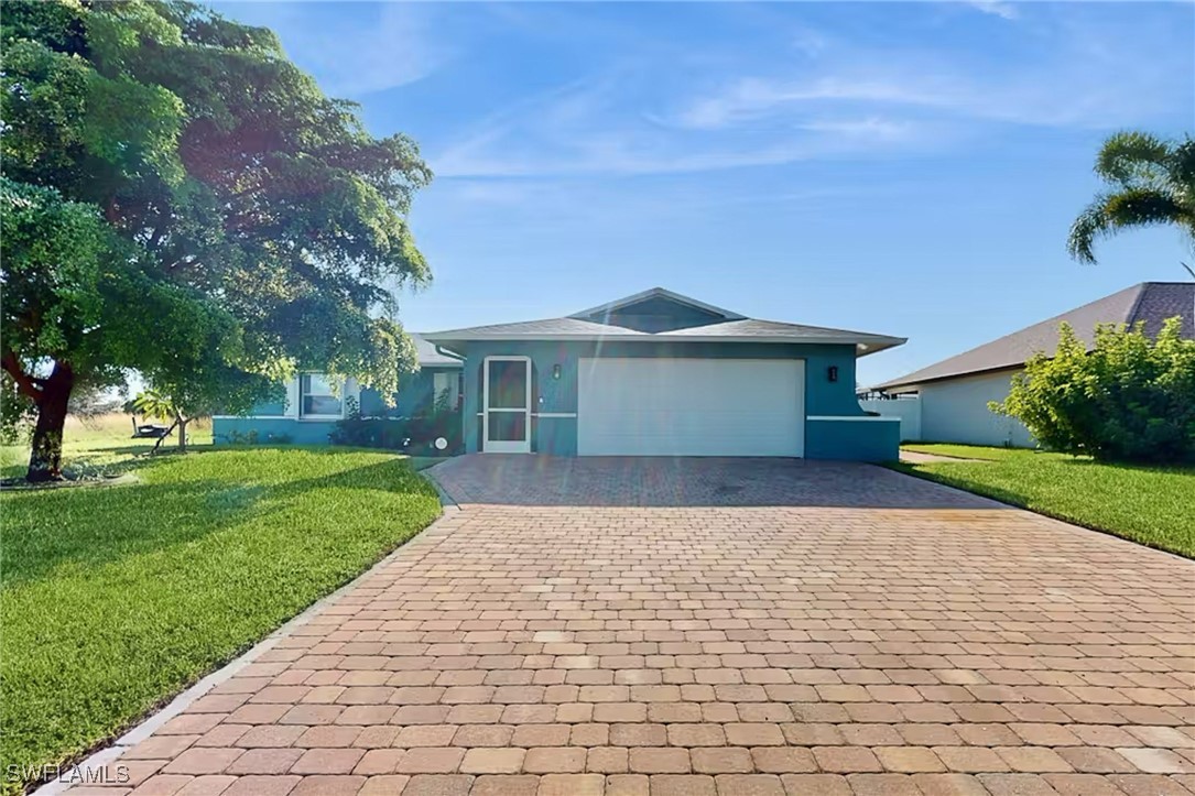 a front view of a house with a yard and trees