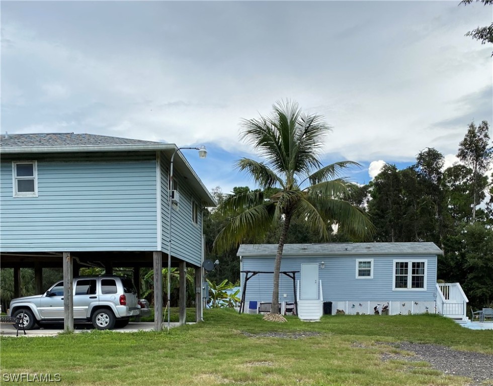 a front view of house with yard and swimming pool